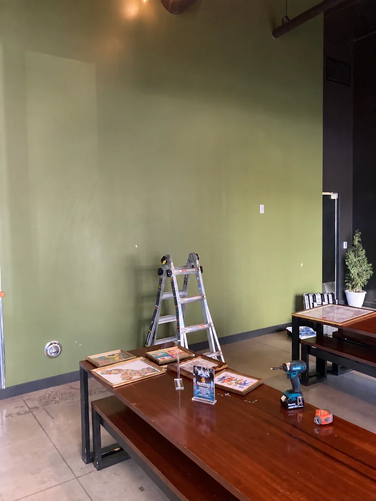 Green wall before framed artwork was arranged
